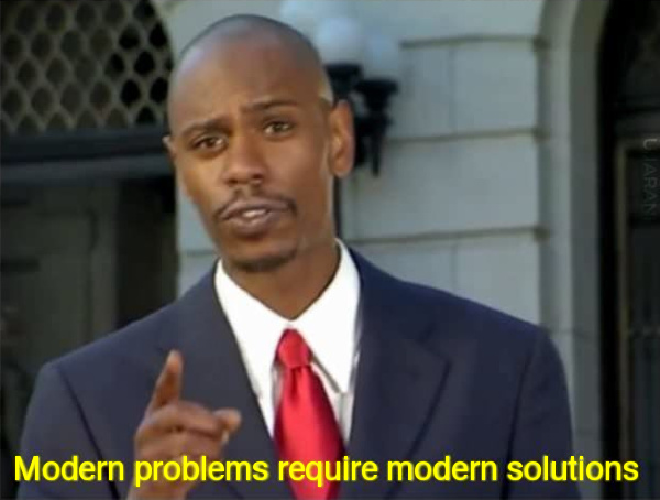A well-known screenshot from a Dave Chappelle skit of Chappelle in a nice suit, pointing his finger and saying 'Modern problems require modern solutions.'