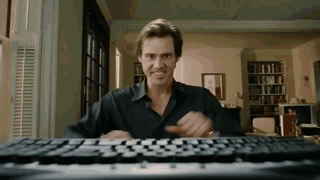 A gif from the movie 'Bruce Almighty' showing the character starting to type slowly and then slowly gaining tremendous speed at the keyboard.