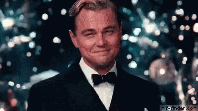 A scene from The Great Gatsby starring Leonardo Dicaprio, raising his glass to the viewer.