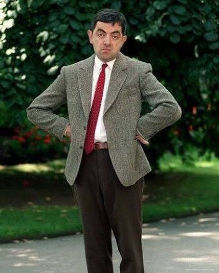 A picture of Mr. Bean staring at the camera, hands on his hips and exasperated expression on his face.