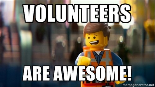 A still from the Lego movie, showing a happy Lego figurine in an orange construction vest with the caption 'VOLUNTEERS' at the top and 'ARE AWESOME!' at the bottom.